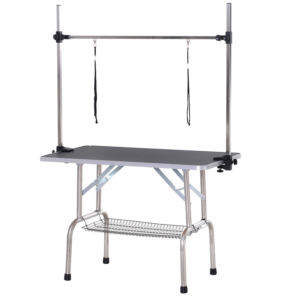 Height-adjustable, foldable grooming table with under-seat basket for dogs